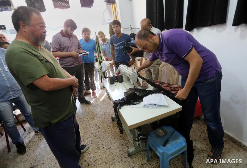 Chinese artist Ai Weiwei looks on as he meets with Palestinian during his work on a documentary film on refugees, in Nuseirat refugee camp in the central Gaza Strip on May 12, 2016. Photo by Mohammed Asad