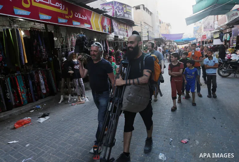 Chinese artist Ai Weiwei and his film crew work on a documentary film on refugees, in Nuseirat refugee camp in the central Gaza Strip on May 12, 2016. Photo by Mohammed Asad
