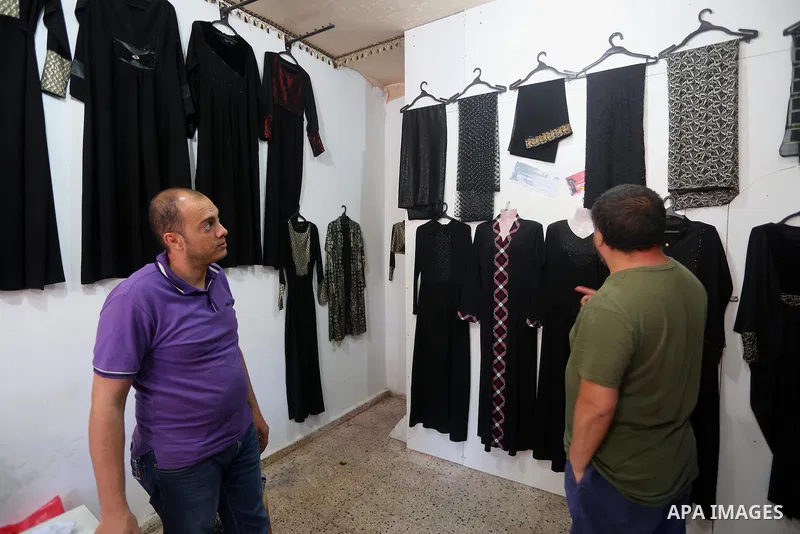 Chinese artist Ai Weiwei looks on as he meets with Palestinian during his work on a documentary film on refugees, in Nuseirat refugee camp in the central Gaza Strip on May 12, 2016. Photo by Mohammed Asad