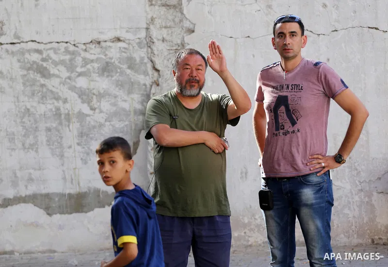 Chinese artist Ai Weiwei and his film crew work on a documentary film on refugees, in Nuseirat refugee camp in the central Gaza Strip on May 12, 2016. Photo by Mohammed Asad