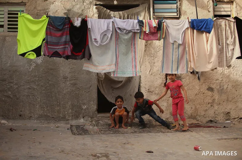 Palestinian kids play on a street on at the al-Shati refugee camp in Gaza City on May 14, 2016. Photo by Ashraf Amra