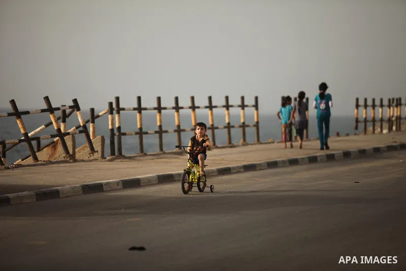 A Palestinian boy rides a bicycle at the al-Shati refugee camp in Gaza City on May 14, 2016. Photo by Ashraf Amra