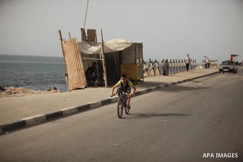 A Palestinian boy rides a bicycle on at the al-Shati refugee camp in Gaza City on May 14, 2016. Photo by Ashraf Amra