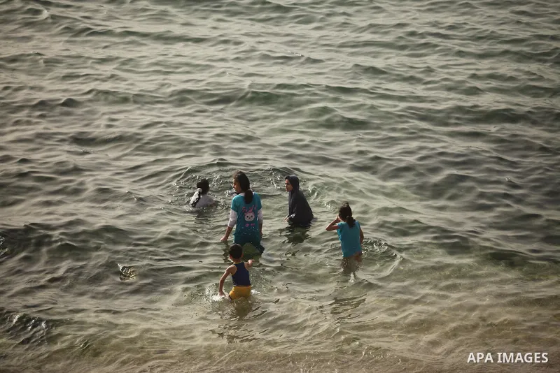 Palestinian children play in the water on the beach at the al-Shati refugee camp in Gaza City on May 14, 2016. Photo by Ashraf Amra