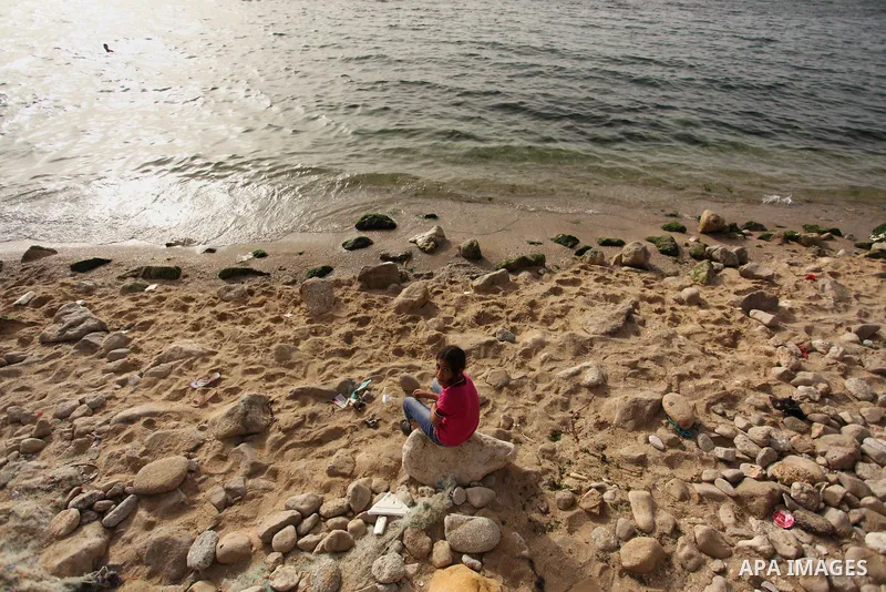 Palestinian children play in the water on the beach at the al-Shati refugee camp in Gaza City on May 14, 2016. Photo by Ashraf Amra