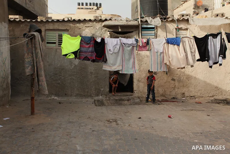 Palestinian kids play on a street on at the al-Shati refugee camp in Gaza City on May 14, 2016. Photo by Ashraf Amra