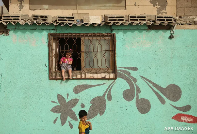 Palestinian kids play on a street on at the al-Shati refugee camp in Gaza City on May 14, 2016. Photo by Ashraf Amra