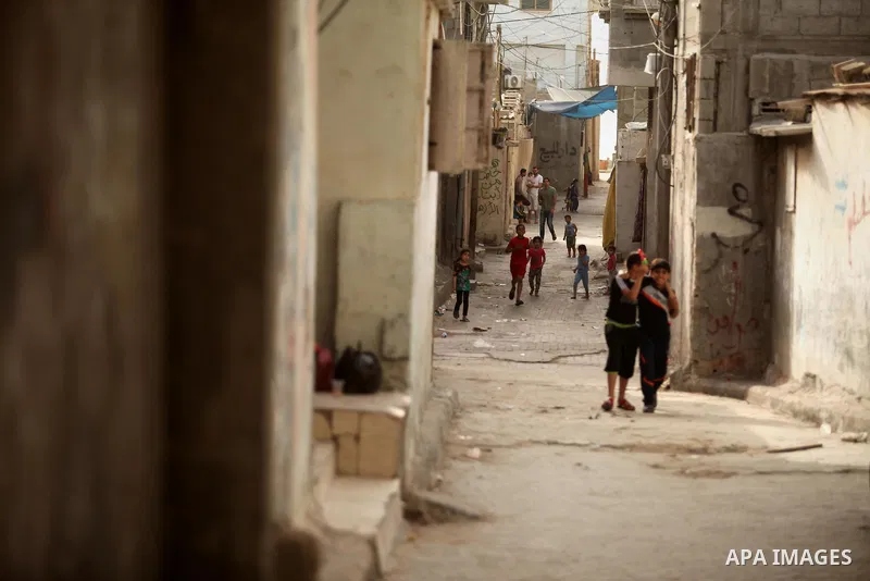 Palestinian kids play on a street on at the al-Shati refugee camp in Gaza City on May 14, 2016. Photo by Ashraf Amra