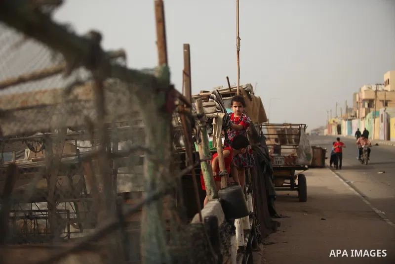 Palestinian kids play on a street on at the al-Shati refugee camp in Gaza City on May 14, 2016. Photo by Ashraf Amra