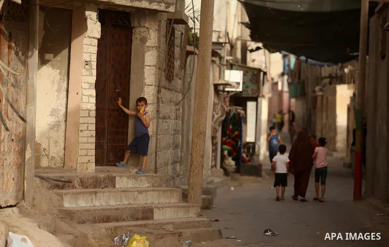 Palestinian kids play on a street on at the al-Shati refugee camp in Gaza City on May 14, 2016. Photo by Ashraf Amra