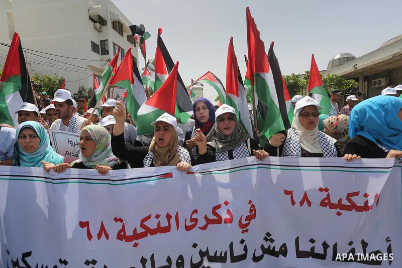 Palestinians wave national flags on May 15, 2016 in Gaza city during a rally to commemorate the "Nakba" or "catastrophe" in Arabic in reference to the establishment in 1948 of the state of Israel. "Nakba" means in Arabic...