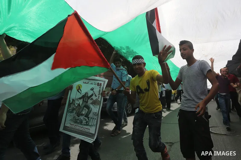 Palestinians wave national flags on May 15, 2016 in Gaza city during a rally to commemorate the "Nakba" or "catastrophe" in Arabic in reference to the establishment in 1948 of the state of Israel. "Nakba" means in Arabic...