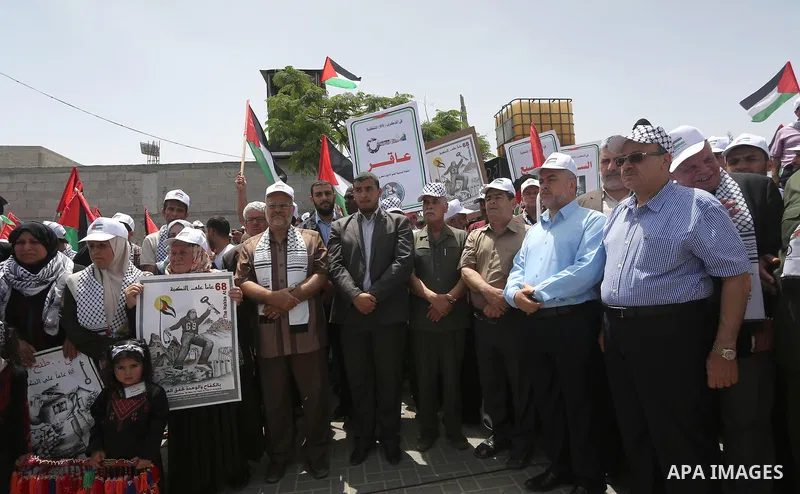 Palestinians wave national flags on May 15, 2016 in Gaza city during a rally to commemorate the "Nakba" or "catastrophe" in Arabic in reference to the establishment in 1948 of the state of Israel. "Nakba" means in Arabic...