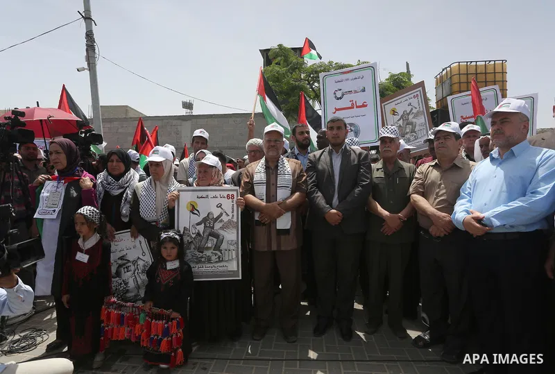 Palestinians wave national flags on May 15, 2016 in Gaza city during a rally to commemorate the "Nakba" or "catastrophe" in Arabic in reference to the establishment in 1948 of the state of Israel. "Nakba" means in Arabic...
