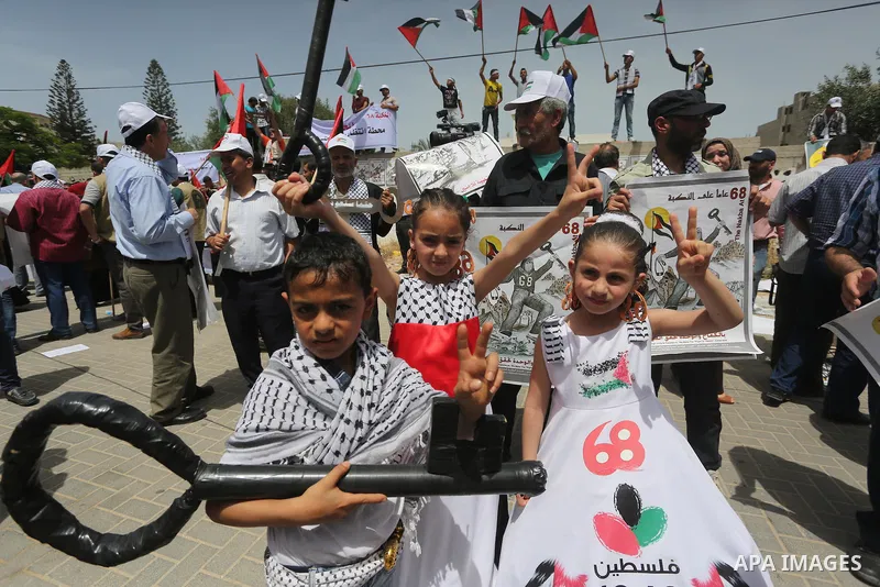 Palestinians wave national flags on May 15, 2016 in Gaza city during a rally to commemorate the "Nakba" or "catastrophe" in Arabic in reference to the establishment in 1948 of the state of Israel. "Nakba" means in Arabic...
