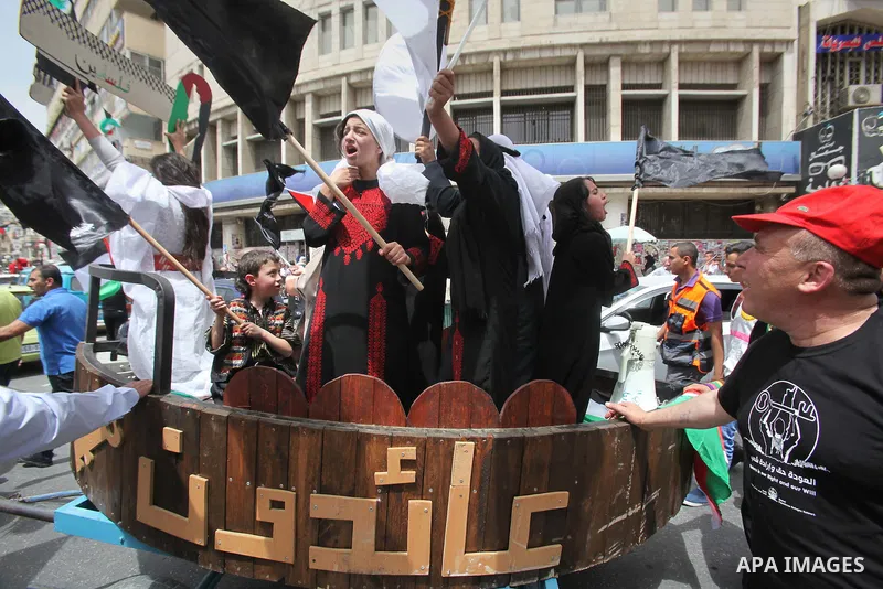 Palestinians wave national flags on May 15, 2016 in the West Bank city of Nablus during a rally to commemorate the "Nakba" or "catastrophe" in Arabic in reference to the establishment in 1948 of the state of Israel. "Nak...