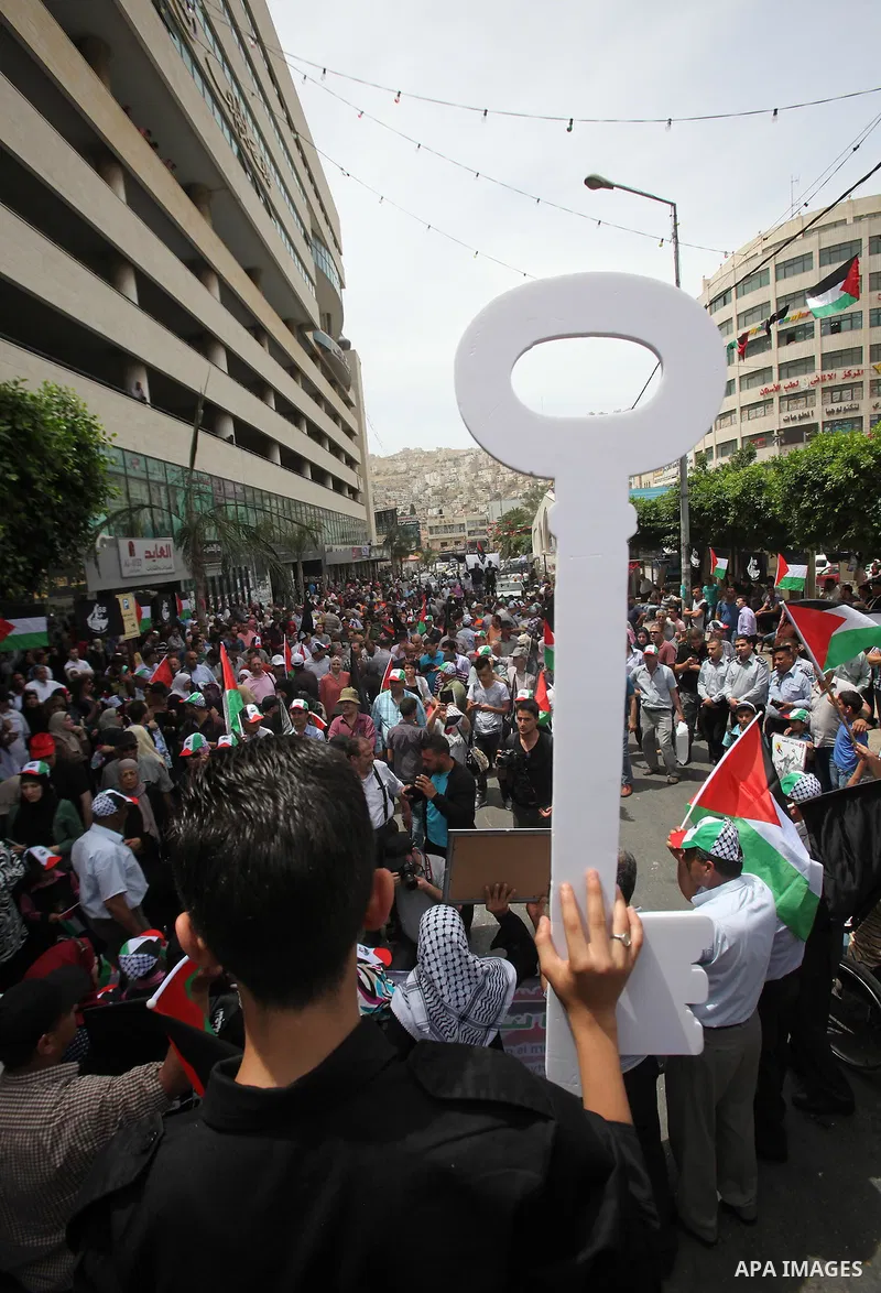 Palestinians wave national flags on May 15, 2016 in the West Bank city of Nablus during a rally to commemorate the "Nakba" or "catastrophe" in Arabic in reference to the establishment in 1948 of the state of Israel. "Nak...