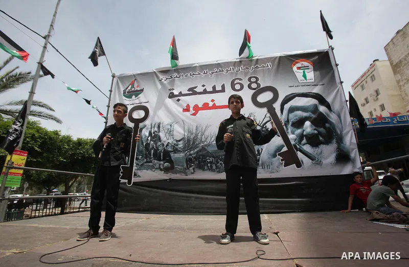 Palestinians wave national flags on May 15, 2016 in the West Bank city of Nablus during a rally to commemorate the "Nakba" or "catastrophe" in Arabic in reference to the establishment in 1948 of the state of Israel. "Nak...