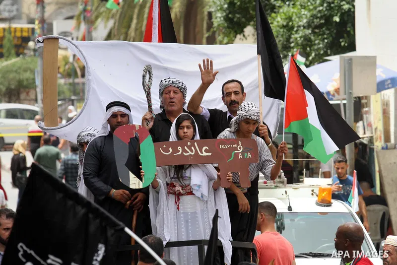 Palestinians wave national flags on May 15, 2016 in the West Bank city of Nablus during a rally to commemorate the "Nakba" or "catastrophe" in Arabic in reference to the establishment in 1948 of the state of Israel. "Nak...