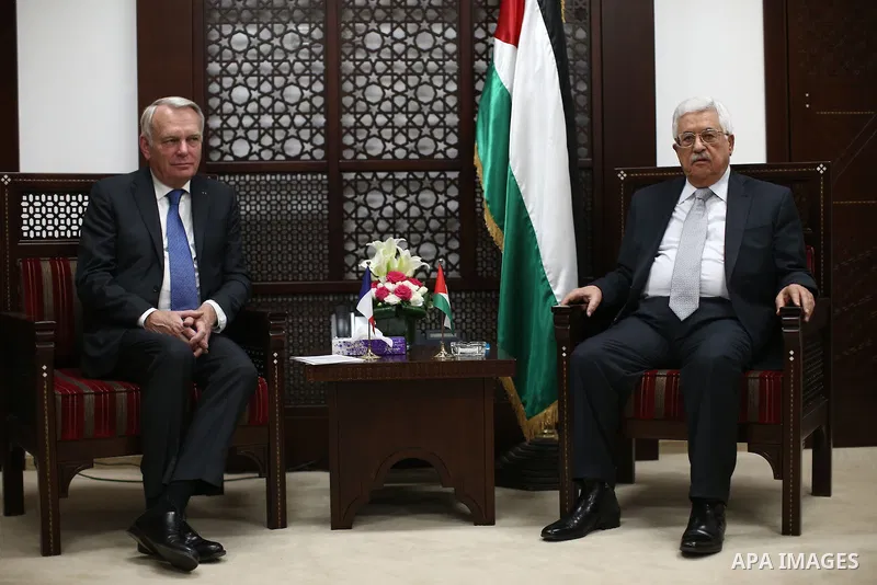Palestinian Foreign Minister Riyad al-Maliki waves to media as French Foreign Minister Jean-Marc Ayrault (R) arrives to meet Palestinian President Mahmoud Abbas in the West Bank city of Ramallah May 15, 2016. apaimages/F...