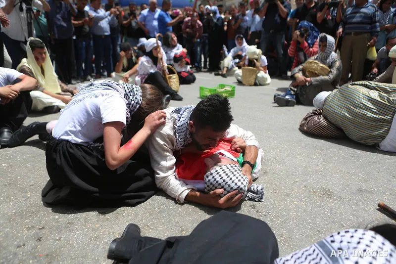 Palestinians re-enact a scene from the 1948 Nakba during a rally marking the 68th anniversary of the Nakba in the West Bank city of Ramallah May 15, 2016. "Nakba" means in Arabic "catastrophe" in reference to the birth o...