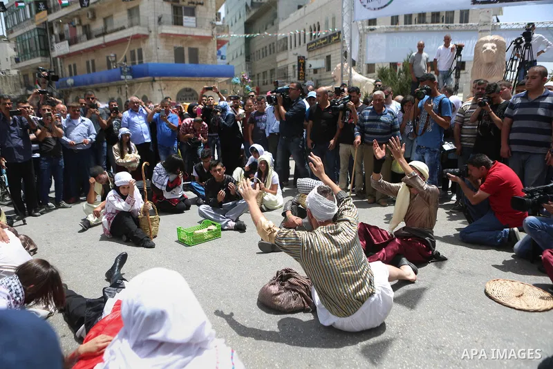 Palestinians re-enact a scene from the 1948 Nakba during a rally marking the 68th anniversary of the Nakba in the West Bank city of Ramallah May 15, 2016. "Nakba" means in Arabic "catastrophe" in reference to the birth o...