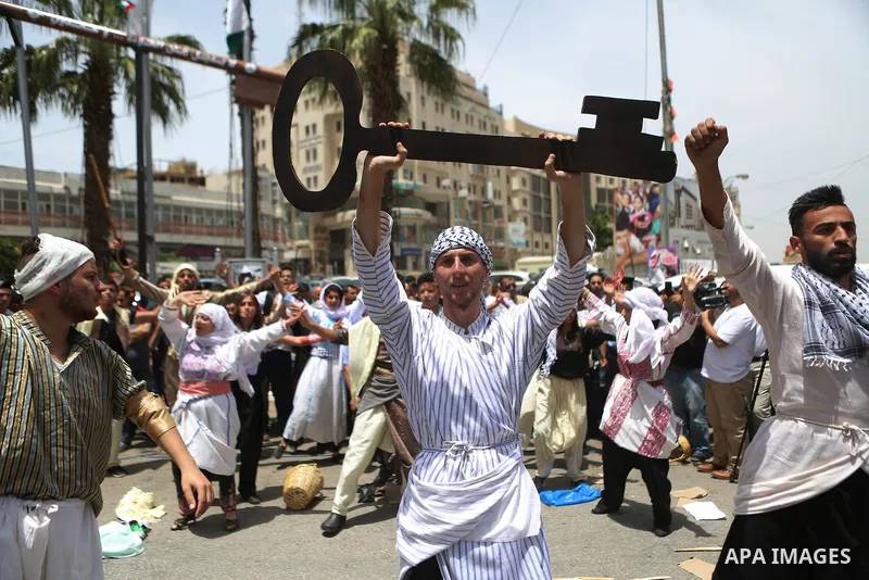 Palestinians re-enact a scene from the 1948 Nakba during a rally marking the 68th anniversary of the Nakba in the West Bank city of Ramallah May 15, 2016. "Nakba" means in Arabic "catastrophe" in reference to the birth o...