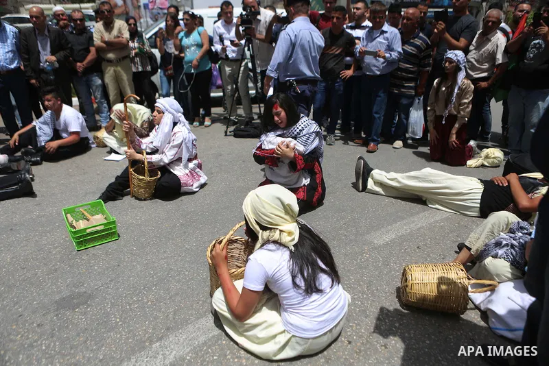 Palestinians re-enact a scene from the 1948 Nakba during a rally marking the 68th anniversary of the Nakba in the West Bank city of Ramallah May 15, 2016. "Nakba" means in Arabic "catastrophe" in reference to the birth o...