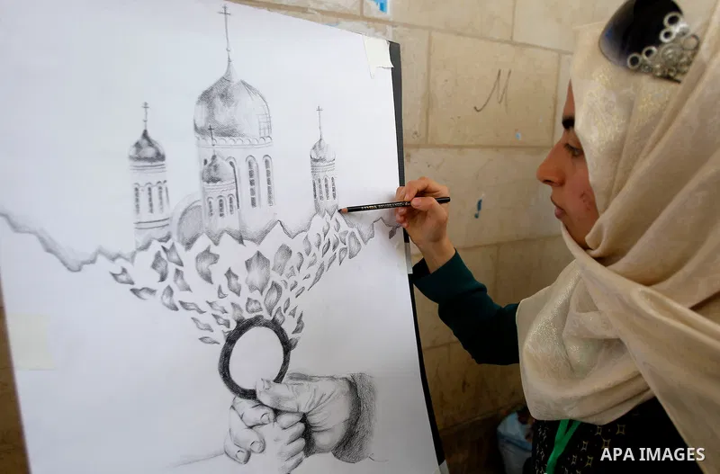 Palestinian artists paint artwork during a rally marking the 68th anniversary of the Nakba in the West Bank city of Hebron May 15, 2016. "Nakba" means in Arabic "catastrophe" in reference to the birth of the state of Isr...