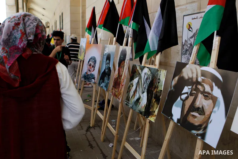 Palestinian artists paint artwork during a rally marking the 68th anniversary of the Nakba in the West Bank city of Hebron May 15, 2016. "Nakba" means in Arabic "catastrophe" in reference to the birth of the state of Isr...
