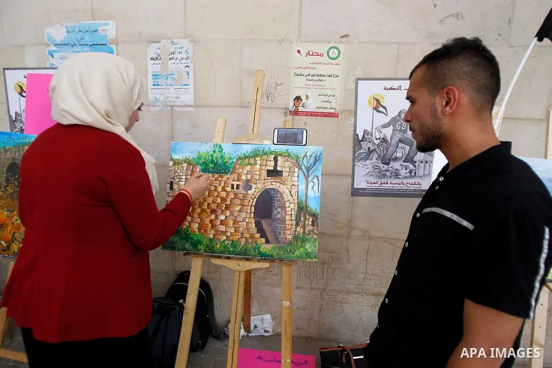 Palestinian artists paint artwork during a rally marking the 68th anniversary of the Nakba in the West Bank city of Hebron May 15, 2016. "Nakba" means in Arabic "catastrophe" in reference to the birth of the state of Isr...