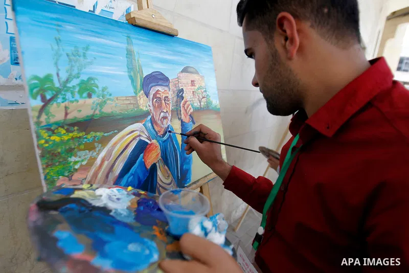 Palestinian artists paint artwork during a rally marking the 68th anniversary of the Nakba in the West Bank city of Hebron May 15, 2016. "Nakba" means in Arabic "catastrophe" in reference to the birth of the state of Isr...
