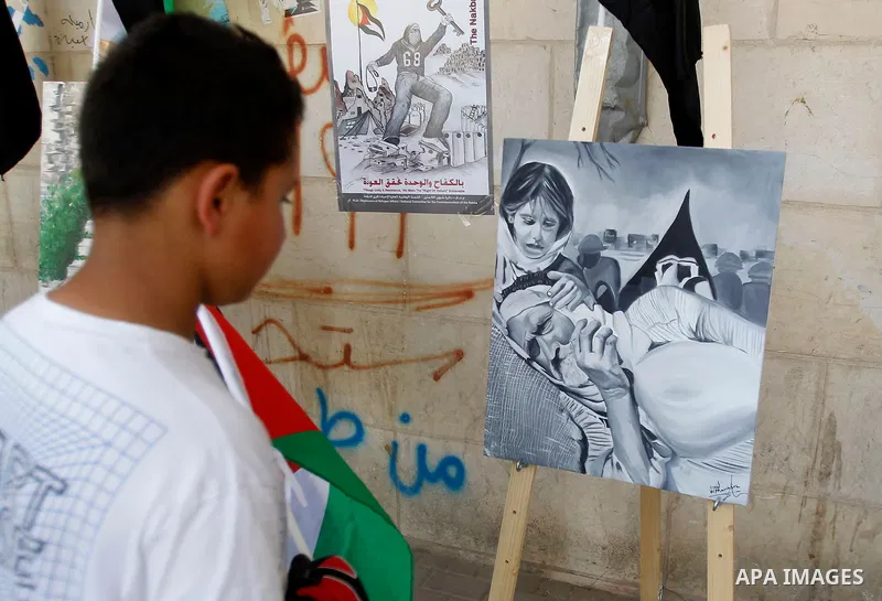 Palestinian artists paint artwork during a rally marking the 68th anniversary of the Nakba in the West Bank city of Hebron May 15, 2016. "Nakba" means in Arabic "catastrophe" in reference to the birth of the state of Isr...