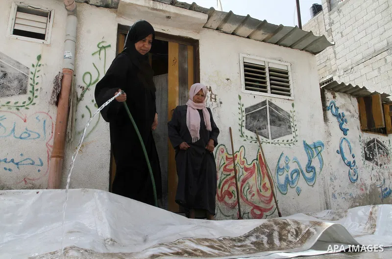 Palestinian women clean outside their houses on the 68th anniversary of the "Nakba" in the southern Gaza Strip town of Khan Younis on May 15, 2016. "Nakba" means in Arabic "catastrophe" in reference to the birth of the s...