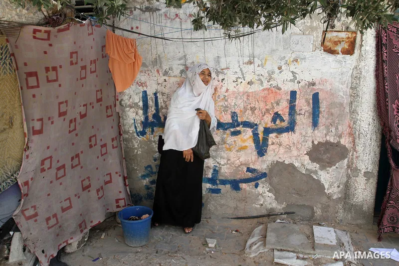 A Palestinian woman stands outside her house on the 68th anniversary of the "Nakba" in the southern Gaza Strip town of Khan Younis on May 15, 2016. "Nakba" means in Arabic "catastrophe" in reference to the birth of the s...