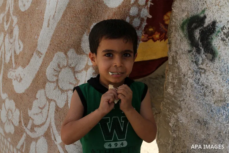 A Palestinian boy stands outside his family house on the 68th anniversary of the "Nakba" in the southern Gaza Strip town of Khan Younis on May 15, 2016. "Nakba" means in Arabic "catastrophe" in reference to the birth of...