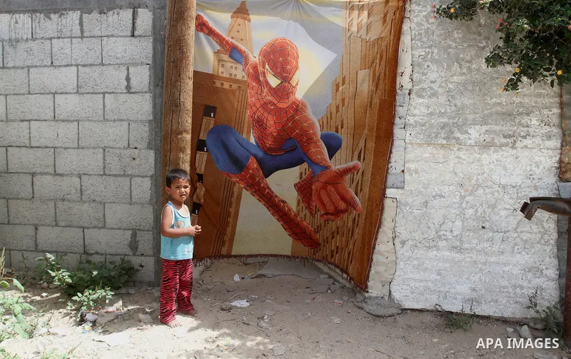 A Palestinian boy stands outside his family house on the 68th anniversary of the "Nakba" in the southern Gaza Strip town of Khan Younis on May 15, 2016. "Nakba" means in Arabic "catastrophe" in reference to the birth of...