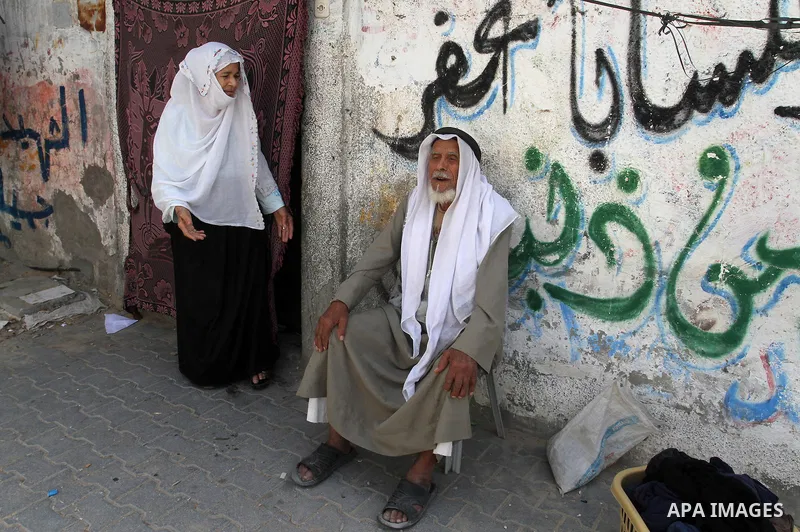A Palestinian man and his wife sit in front of their house on the 68th anniversary of the "Nakba" in the southern Gaza Strip town of Khan Younis on May 15, 2016. "Nakba" means in Arabic "catastrophe" in reference to the...