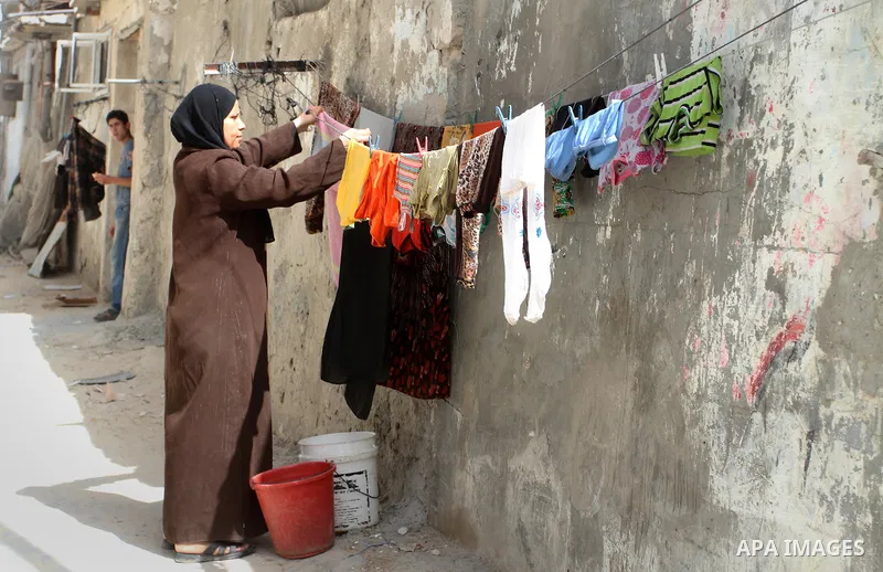 A Palestinian woman hangs laundry outside her house on the 68th anniversary of the "Nakba" in the southern Gaza Strip town of Khan Younis on May 15, 2016. "Nakba" means in Arabic "catastrophe" in reference to the birth o...