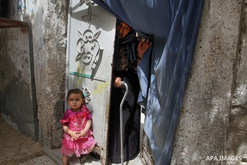 A Palestinian woman stands outside her house on the 68th anniversary of the "Nakba" in the southern Gaza Strip town of Khan Younis on May 15, 2016. "Nakba" means in Arabic "catastrophe" in reference to the birth of the s...