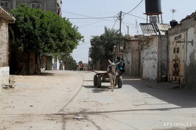 A Palestinian man rides a cart with a donkey at street on the 68th anniversary of the "Nakba" in the southern Gaza Strip town of Khan Younis on May 15, 2016. "Nakba" means in Arabic "catastrophe" in reference to the birt...