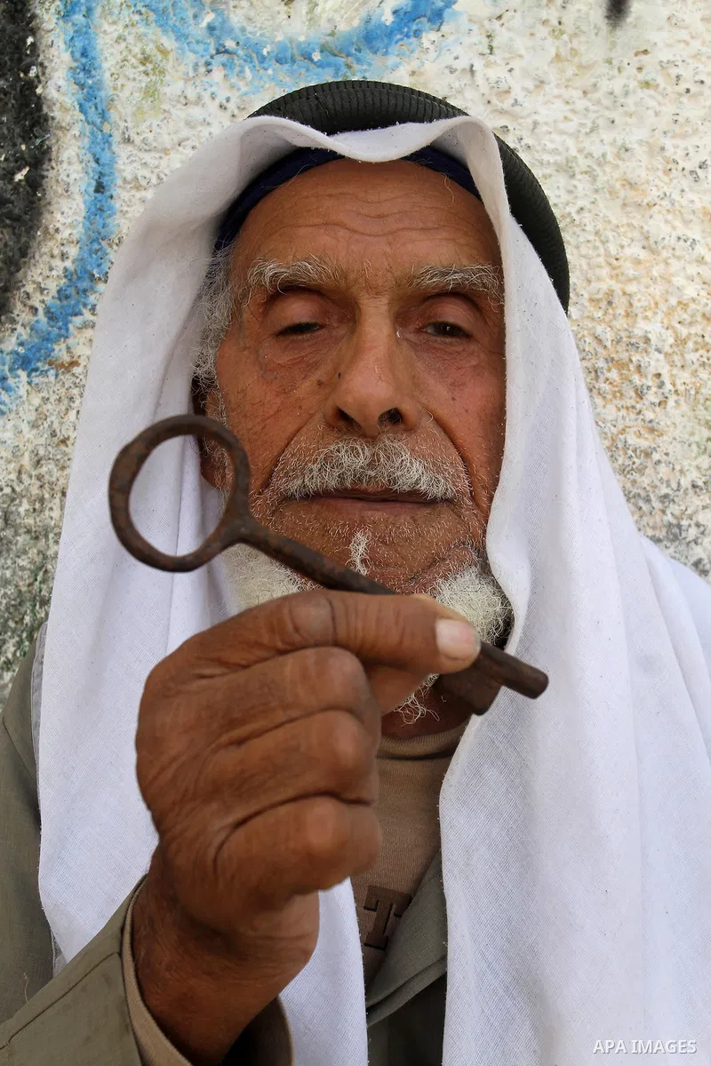 A palestinian man holds key symbolising the homes they left in 1948 in front of his house in the southern Gaza Strip town of Khan Younis on May 15, 2016. "Nakba" means in Arabic "catastrophe" in reference to the birth of...