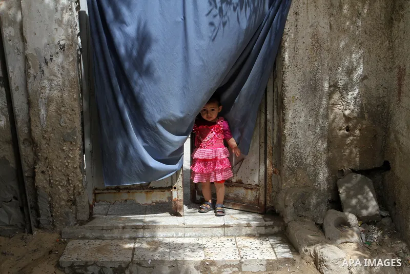 A Palestinian girl stands outside his family house on the 68th anniversary of the "Nakba" in the southern Gaza Strip town of Khan Younis on May 15, 2016. "Nakba" means in Arabic "catastrophe" in reference to the birth of...