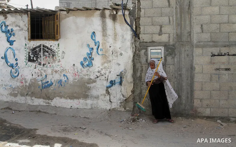 A Palestinian woman cleans outside her house on the 68th anniversary of the "Nakba" in the southern Gaza Strip town of Khan Younis on May 15, 2016. "Nakba" means in Arabic "catastrophe" in reference to the birth of the s...
