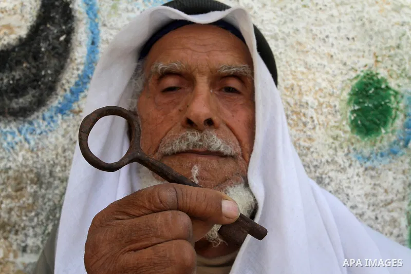 A palestinian man holds key symbolising the homes they left in 1948 in front of his house in the southern Gaza Strip town of Khan Younis on May 15, 2016. "Nakba" means in Arabic "catastrophe" in reference to the birth of...