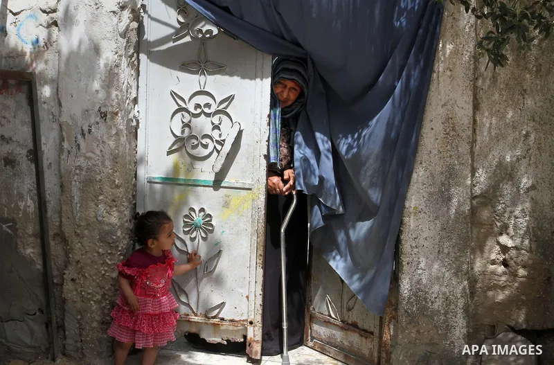 A Palestinian woman stands outside her house on the 68th anniversary of the "Nakba" in the southern Gaza Strip town of Khan Younis on May 15, 2016. "Nakba" means in Arabic "catastrophe" in reference to the birth of the s...