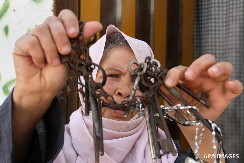 A Palestinian woman holds keys symbolising the homes they left in 1948 in front of her house on the 68th anniversary of the "Nakba" in the southern Gaza Strip town of Khan Younis on May 15, 2016. "Nakba" means in Arabic...