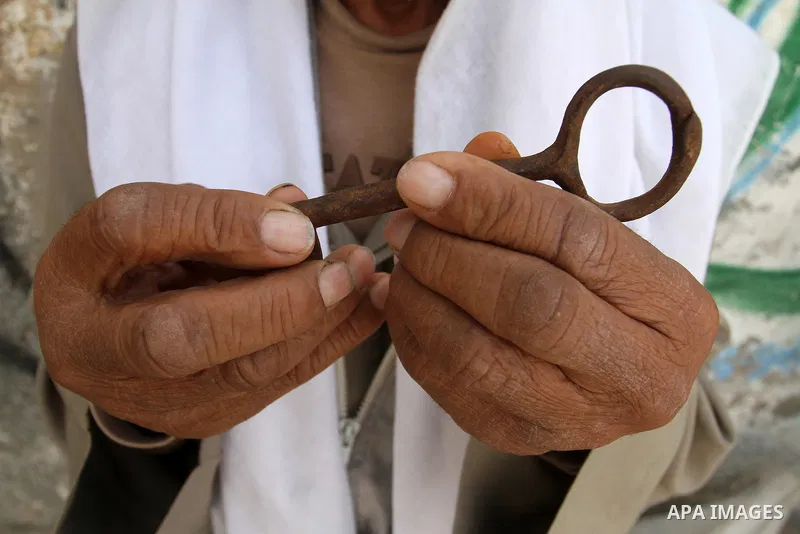 A palestinian man holds key symbolising the homes they left in 1948 in front of his house in the southern Gaza Strip town of Khan Younis on May 15, 2016. "Nakba" means in Arabic "catastrophe" in reference to the birth of...