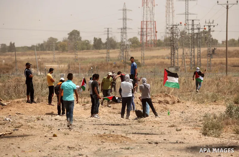 Palestinians take part during a rally to commemorate the "Nakba" or "catastrophe" in Arabic in reference to the establishment in 1948 of the state of Israel near the Nahal Oz crossing east of Gaza City on May 15, 2016. "...