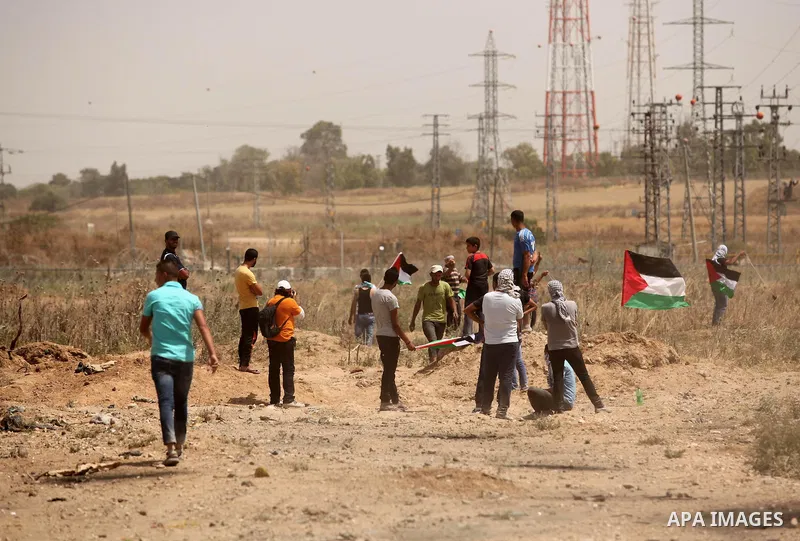 Palestinians take part during a rally to commemorate the "Nakba" or "catastrophe" in Arabic in reference to the establishment in 1948 of the state of Israel near the Nahal Oz crossing east of Gaza City on May 15, 2016. "...